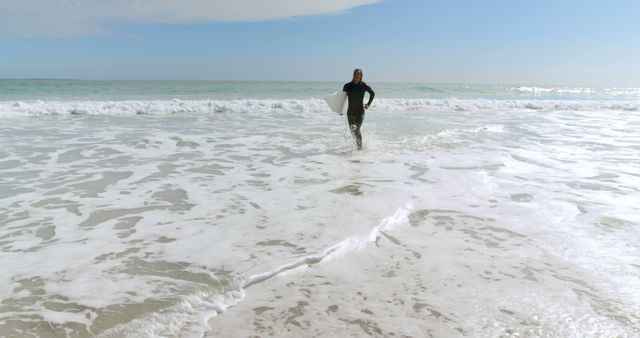 Surfer Walking Out of Ocean on Sunny Day - Download Free Stock Images Pikwizard.com