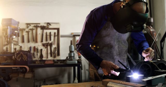 Welder Working in Industrial Workshop with Tools in Background - Download Free Stock Images Pikwizard.com