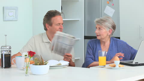 Senior Couple Enjoys Breakfast Together in Modern Kitchen