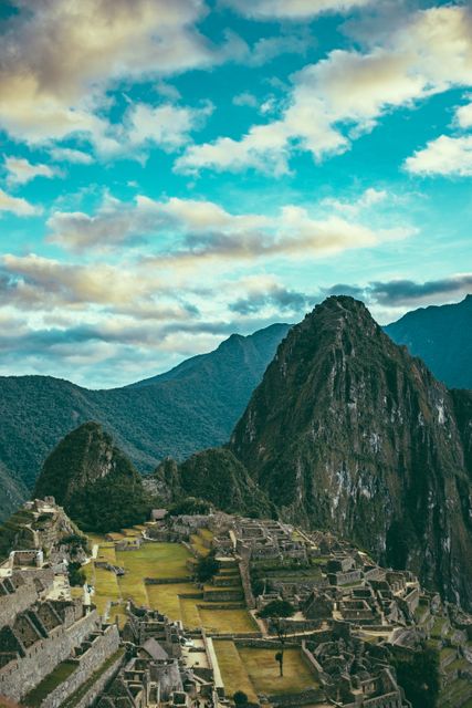 Breathtaking panoramic view of Machu Picchu with vibrant sky and scenic mountainous landscape. Perfect for travel brochures, tourism websites, historical site features, and educational materials on Inca civilization. Ideal for promoting Peru and UNESCO World Heritage sites.