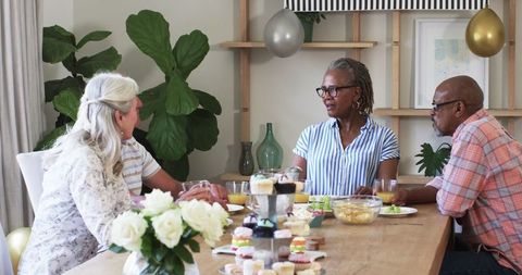 Friends Enjoy Socializing and Snacks at Home Gathering