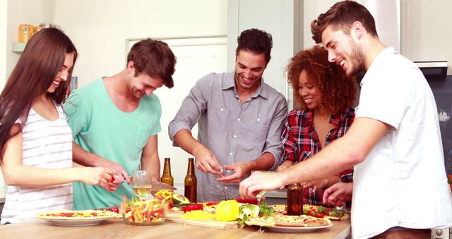 Group of Friends Making Pizza and Having Fun in Kitchen - Download Free Stock Images Pikwizard.com