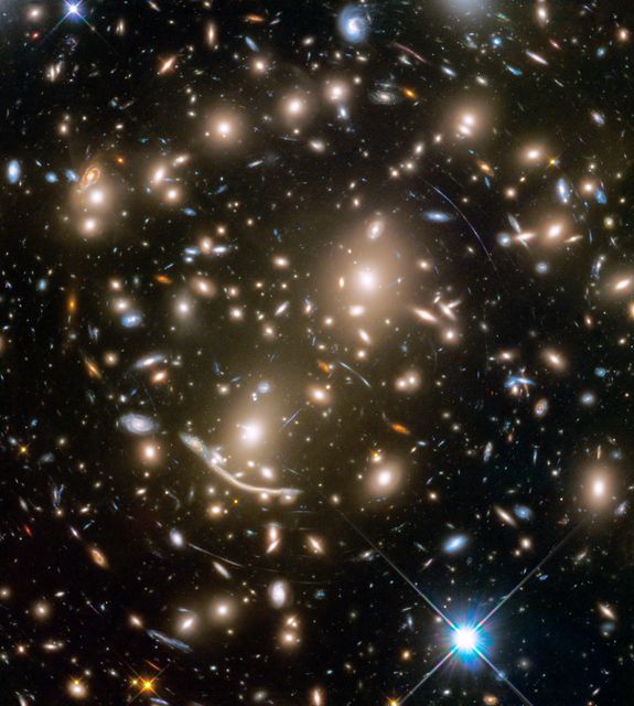 This image captured by the Hubble Space Telescope shows the galaxy cluster Abell 370 featuring hundreds of galaxies held by gravity. The brightest yellow-white objects are massive elliptical galaxies, while bluish spirals signify younger star populations. Blue arcs are distorted images from more remote galaxies due to gravitational lensing. Useful for layouts on astronomy, space exploration, and cosmic phenomena.