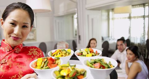 Waitress Serving Tasty Asian Vegetable Cuisine