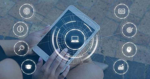 Adult female holding tablet tapping HUD overlay for e-learning and digital analytics