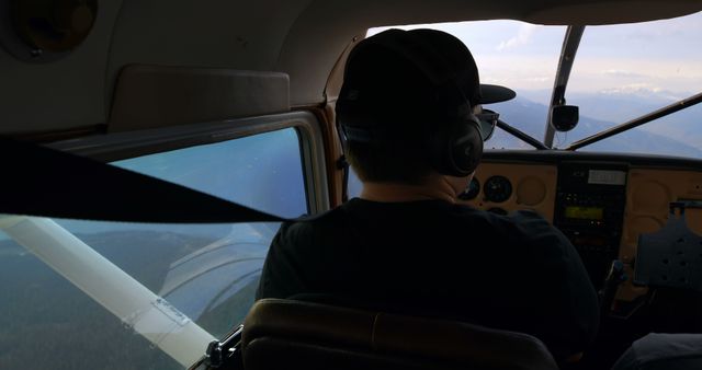 Pilot Controlling Light Aircraft in Clear Sky - Download Free Stock Images Pikwizard.com