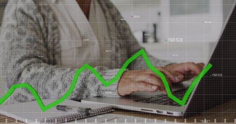 Elderly woman analyzing financial data on laptop
