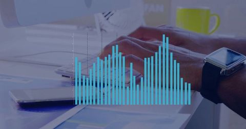 Hands Typing on Desk with Digital Bar Chart Overlaying Data Concept