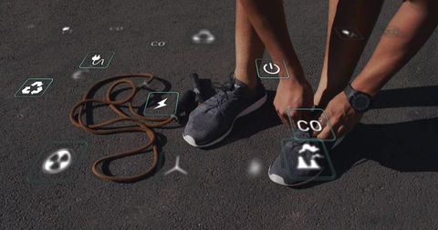 Tying running shoe laces before workout with augmented reality fitness icons and jump rope