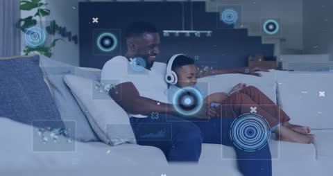 Father and Son Using Tablet with Digital Interface Elements