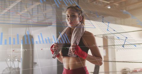 Woman in Boxing Gym Enhancing Workouts with Fitness Analytics