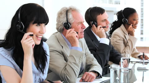 Diverse Call Center Team Collaborating with Headsets