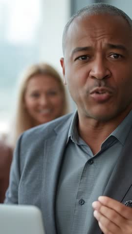 Delivering confident message in vertical video: Business leader speaking and gesturing in office