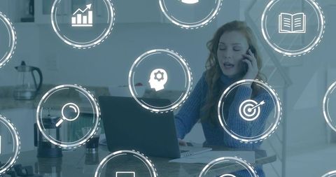 Woman Speaking on Phone While Typing on Laptop at Home Kitchen Counter with UX Icons