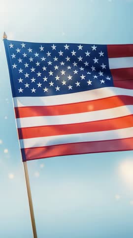 Vertical US Flag Waving on Wooden Pole with Sunlight Particles and Soft Sky Background