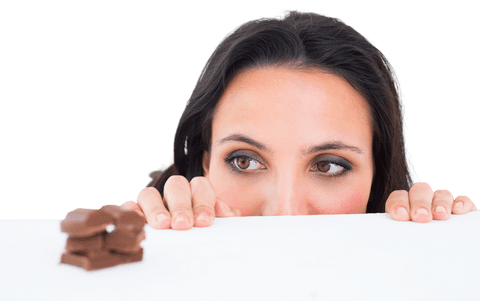 Brunette Woman Peeking at Milk Chocolate Slices on Transparent Background