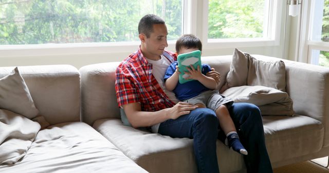 Father and Son Bonding in Living Room with Tablet - Download Free Stock Images Pikwizard.com