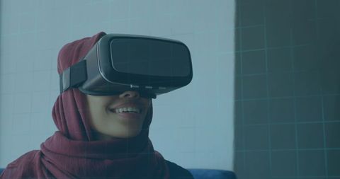 Smiling Woman in Hijab Experiencing Virtual Reality Technology