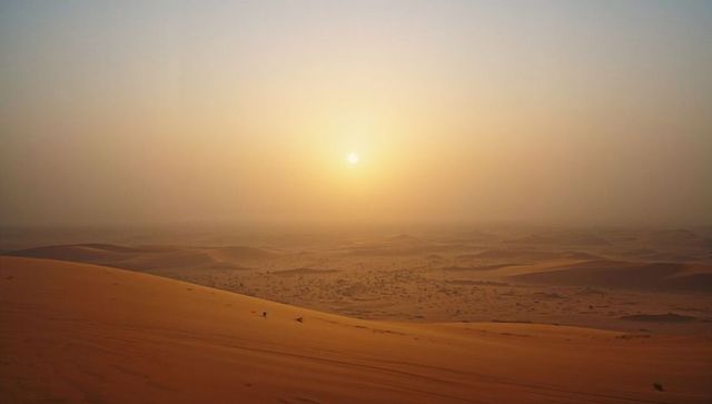 Expansive Desert Dunes Illuminated by Stunning Sunrise