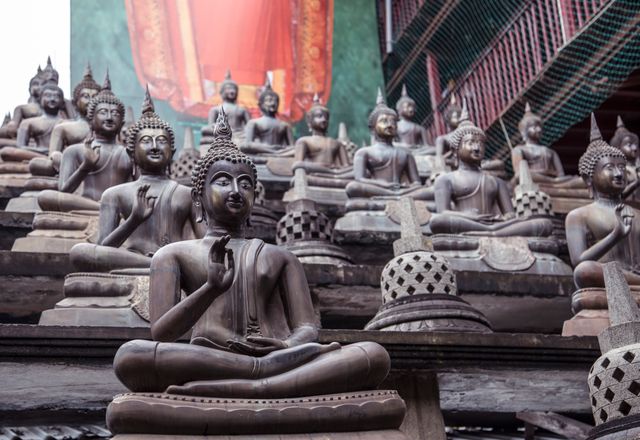 Buddha statues sitting in meditation at Seema Malaka Temple in Colombo, Sri Lanka. Ideal for articles on travel, religious places, spirituality, and cultural heritage. Can be used in educational and informative materials about Buddhism and Southeast Asian art. Perfect for tourists planning to visit Sri Lanka or for those interested in historical temples and cultural preservation.