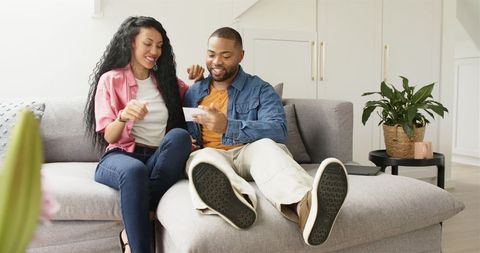 Couple joyfully sharing pregnancy news at home