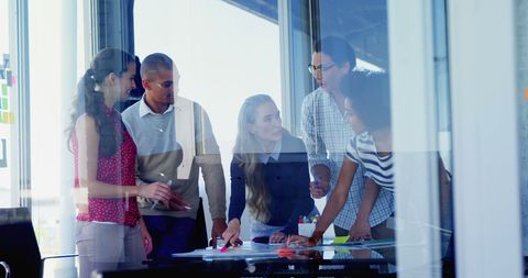 Diverse Team Collaborating in Modern Office Environment on Project - Download Free Stock Images Pikwizard.com