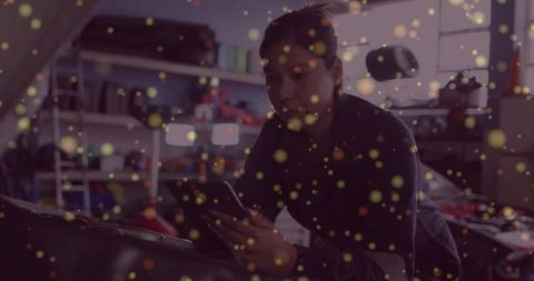 Woman mechanic consulting smartphone in auto repair shop