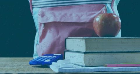 Pink Backpack with School Supplies and Apple on Desk