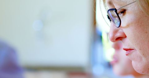 Focused Woman Wearing Glasses Analyzing Data with Copy Space