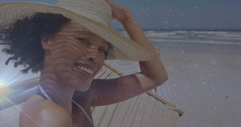 Woman Relaxing on Hammock by Beach with Straw Hat and Tropical Vibes