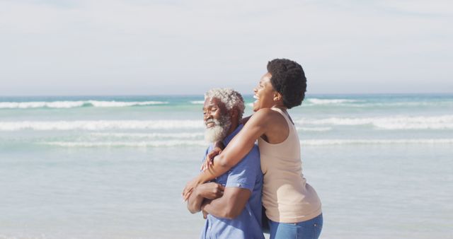 Mature couple enjoying time together on a beautiful beach. This image is perfect for use in advertisements promoting retirement planning, vacations designed for seniors, or lifestyle content focused on joy and relaxation in older age. It can also be used in health and wellness campaigns highlighting the importance of relationships and well-being.