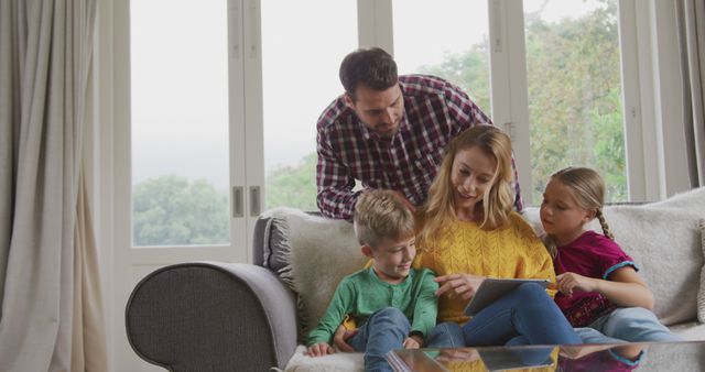 Happy Family Using Digital Tablet at Home Together - Download Free Stock Images Pikwizard.com