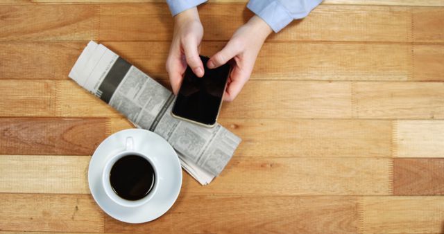 Person Using Smartphone and Drinking Coffee at Wooden Table - Download Free Stock Images Pikwizard.com