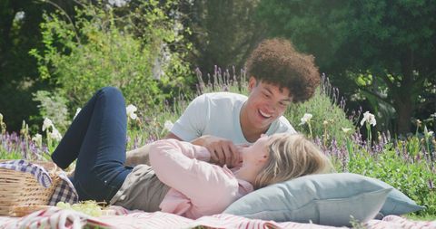 Diverse Couple Enjoying Picnic in Blooming Garden