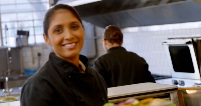 Smiling Female Chef in Professional Kitchen - Download Free Stock Images Pikwizard.com