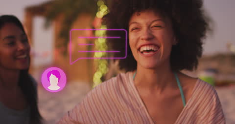 Women Enjoying Social Media Interaction at Beach At Sunset