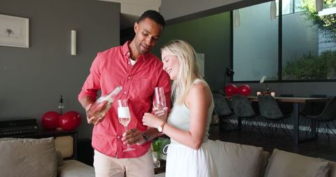Happy Couple Enjoying Champagne Celebration at Home