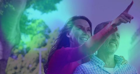 Happy Mature Couple Exploring Sunlit Urban Street