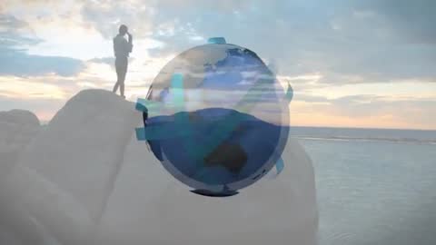 Silhouette of Woman by Ocean with Futuristic Digital Globe