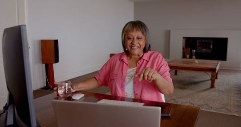 Senior Woman Enjoying Remote Work at Home with Laptop in Cozy Room