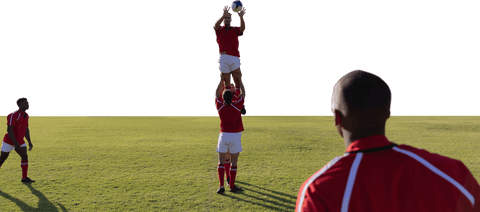 Male rugby player catching football in action on field transparent