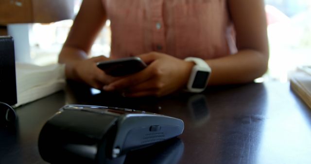 Teenage girl making payment through smartwatch in restaurant 4k