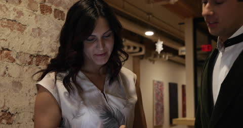 Colleagues Collaborating on Tablet in Casual Office Corridor