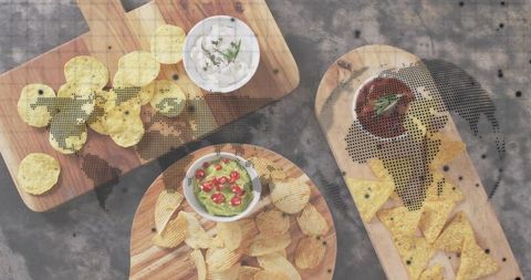 Showcasing snack platters with guacamole chips and salsa over halftone world map overlay flatlay