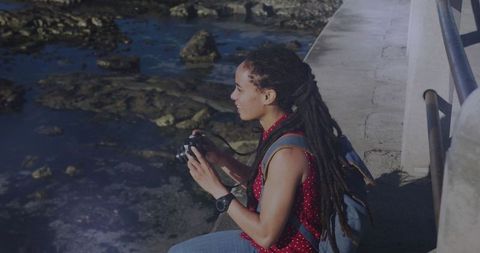 Woman with Camera Capturing Waterfront Moments at Sunrise - Download Free Stock Images Pikwizard.com