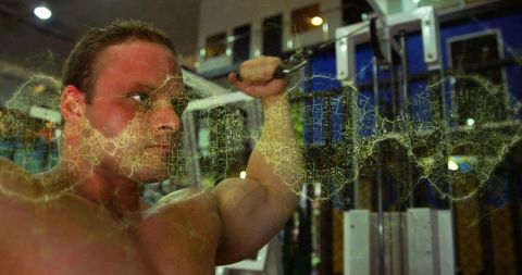 Muscular man pulling cable on gym machine with scratched grunge texture overlay