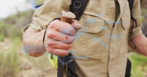 Explorer Holding Trekking Pole on Nature Trail