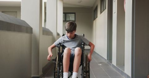 Young Boy in Wheelchair Manoeuvring School Corridor Independently - Download Free Stock Images Pikwizard.com