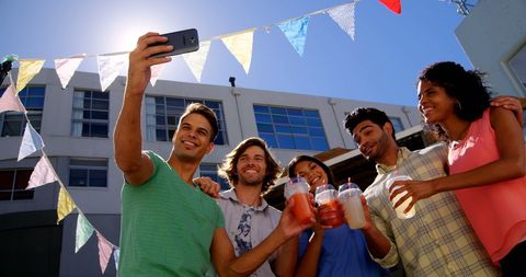 Diverse Friends Capturing Sunny Day with Selfie Outdoors