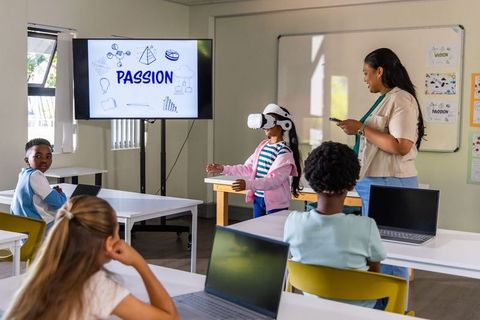 Teacher leading vr lesson with students in modern classroom displaying passion